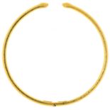ILIAS LALAOUNIS.  A GREEK GOLD SERPENT NECK RING hinged at the centre, approximately 132mm diam,
