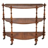 A VICTORIAN SERPENTINE WALNUT THREE TIER WHATNOT, C1870 in matched veneers, the four baluster