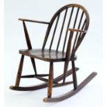 AN ERCOL F182 ELM ROCKING CHAIR, C1960 Condition report  Rubbed, scuffed and scratched in places