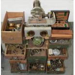 A WOOD CHEST OF DRAWERS WITH BRASS CUP HANDLES CONTAINING MISCELLANEOUS CLOCK AND WATCHMAKER'S