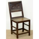 AN ENGLISH JOINED OAK PANEL BACK CHAIR, C1700, THE PANEL CARVED WITH STRAPWORK, BOARDED SEAT, 93CM H