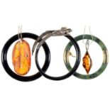 A GILTMETAL MOUNTED NEPHRITE BANGLE, 75MM DIAM, TWO OTHER BANGLES AND TWO AMBER PENDANTS, ONE SILVER
