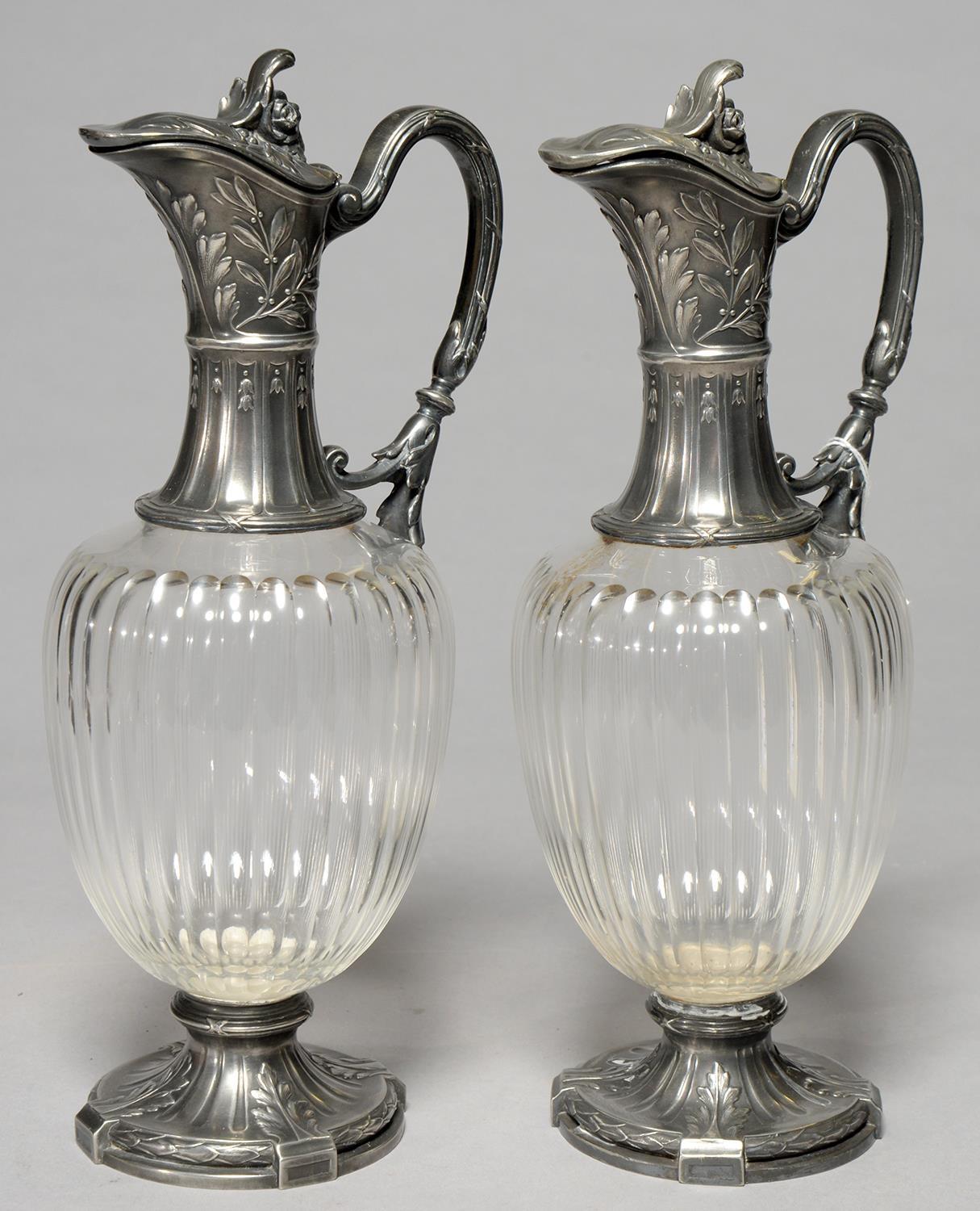 A PAIR OF CONTINENTAL SILVERED PEWTER MOUNTED FLUTED GLASS CLARET JUGS, 20TH C, 29CM H Condition