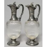 A PAIR OF CONTINENTAL SILVERED PEWTER MOUNTED FLUTED GLASS CLARET JUGS, 20TH C, 29CM H Condition