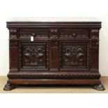 A PROFUSELY CARVED AND STAINED BUFFET, FITTED WITH DRAWERS AND ENCLOSED BY DOORS DECORATED WITH