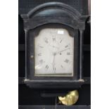 AN EBONISED HOODED WALL TIMEPIECE, THE SHAPED AND SILVERED DIAL WITH SUBSIDIARY SECONDS DIAL AND