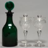 AN ENGLISH GREEN GLASS DECANTER AND TARGET STOPPER, C1900, POLISHED PONTIL SCAR, 28CM H AND A PAIR