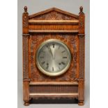 A GERMAN CARVED OAK MANTEL CLOCK, C1900, OF ARCHITECTURAL FORM, WITH TURNED FINIALS, SILVERED DIAL