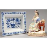 A CONTINENTAL PORCELAIN FIGURE OF A YOUNG GIRL EMBLEMATIC OF SMELL FROM THE FIVE SENSES,