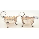 A PAIR OF EDWARD VII SILVER SAUCE BOATS, WITH C SCROLL HANDLE, ON HOOF FEET, 13CM L, BY NATHAN AND