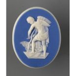 AN ADAMS BLUE JASPER DIP PLAQUE OF CUPID SHAVING HIS BOW, 19TH C, 5CM, IMPRESSED MARK, EARLY 19TH