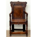 A JOINED OAK PANEL BACK ARMCHAIR, EARLY 20TH C, IN 17TH C STYLE, THE PANEL INCISED WITH AN ARCH, THE