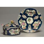 A WORCESTER SCALE BLUE GROUND BUTTER DISH, COVER AND STAND, C1770, PAINTED WITH FLORAL RESERVES,