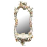 A GERMAN FRUIT AND FLORAL ENCRUSTED PORCELAIN MIRROR, C1890, OF TYPICAL SCROLLING FORM WITH
