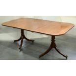 A MAHOGANY TWIN PILLAR DINING TABLE,  20TH C, IN GEORGE III STYLE, BRASS PAW CASTORS, WITH A