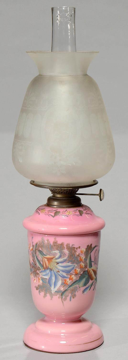 A VICTORIAN GLASS OIL LAMP C1890, OF OPAL GLASS CASED IN BLANMANGE PINK AND PAINTED WITH LILLIES,