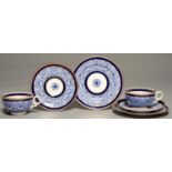 A PAIR OF ROYAL WORCESTER ROYAL LILY PATTERN BREAKFAST CUPS, SAUCERS AND PLATES, 1890 AND 1905,