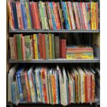 THREE SHELVES OF CHILDREN'S BOOKS, INCLUDING DANDY, BEANO, EAGLE AND OTHER ANNUALS, 1960S AND