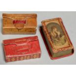 NEEDLEWORK TOOLS. THREE SCARLET OR TAN MOROCCO BOOK SHAPED NEEDLE BOXES, TWO OF WALLET TYPE, EARLY