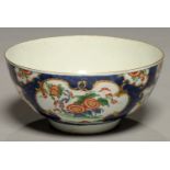 A WORCESTER SCALE BLUE GROUND KAKIEMON BOWL, C1770, WITH CHRYSANTHEMUM AND BANDED HEDGE