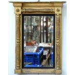 AN EARLY VICTORIAN GILTWOOD AND COMPOSITION PIER GLASS, THE LATER BEVELLED MIRROR IN REEDED EBONISED