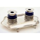 AN EDWARD VII SILVER INKSTAND WITH BEADED EDGE AND PAIR OF SILVER CAPPED CYLINDRICAL BLUE GLASS