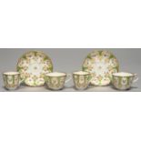 A PAIR OF JOHN RIDGWAY APPLE GREEN GROUND MOULDED TRIOS, C1850, PAINTED WITH SMALL FLOWERS WITH
