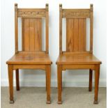 A PAIR OF VICTORIAN PITCH PINE HALL CHAIRS, C1870, THE CREST RAIL CARVED WITH STYLISED FLOWERS, ON