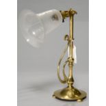 AN ART NOUVEAU EARLY ELECTRIC ADJUSTABLE BRASS TABLE LAMP, EARLY 20TH C, ON DOMED BASE AND BUN FEET,