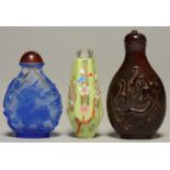 THREE CHINESE SNUFF BOTTLES, COMPRISING BLUE OVERLAY GLASS CARVED WITH A QILIN, TAPERED HEXAGONAL