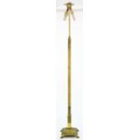 A BRASS STANDARD LAMP, THE SQUARE BASE ON PAW FEET, 180CM H Minor scuffs and scratches consistent