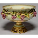 A MANGANI PORCELAIN CENTREPIECE, LATE 20TH C, OF VASE FORM, APPLIED WITH GRAPEVINES ON A GREEN