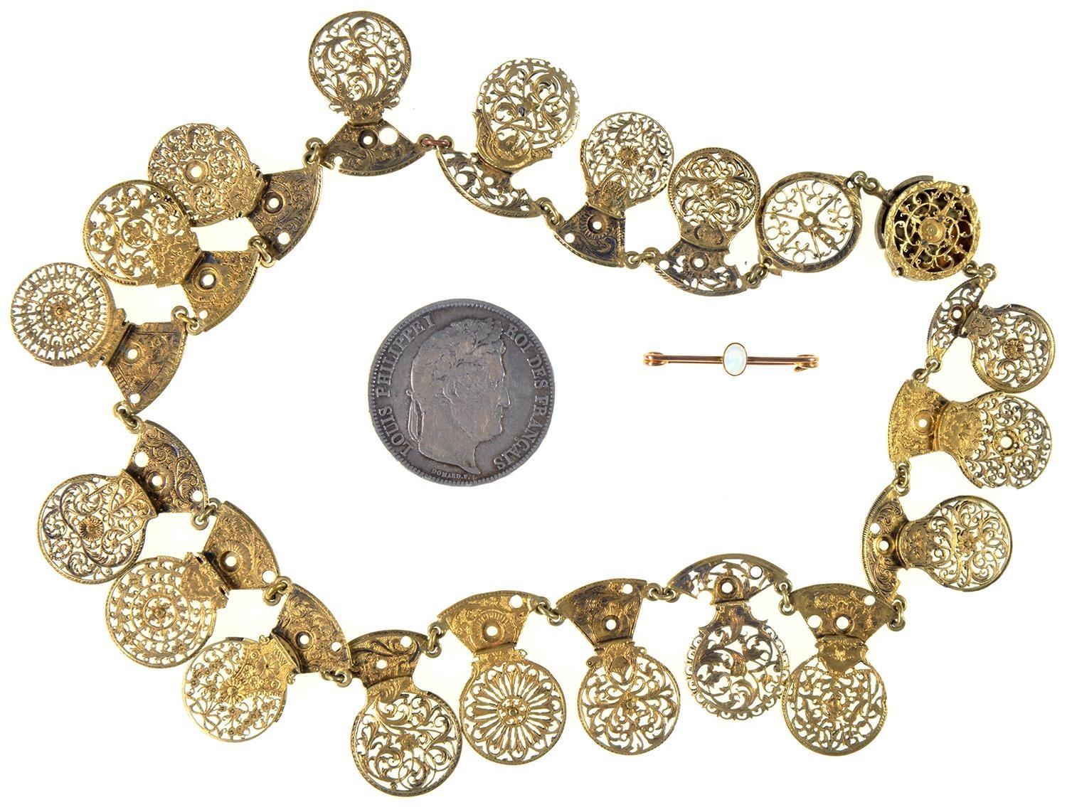 A NECKLACE COMPOSED OF ENGLISH PIERCED BRASS VERGE WATCH COCKS, 18TH AND EARLY 19TH C, EACH LINKED