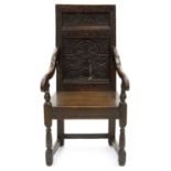 A CHARLES II STYLE OAK PANELLED BACK ARMCHAIR, INLAID IN HOLLY AND BOG OAK, SEAT HEIGHT 46CM Back