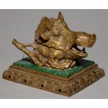 A CONTINENTAL CAST BRASS AND MALACHITE DECORATED PORCELAIN INKWELL IN THE FORM OF THE HEAD OF A