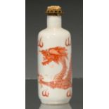 A CHINESE PORCELAIN SNUFF BOTTLE, 19TH / EARLY 20TH C, PAINTED IN RED MONOCHROME WITH A DRAGON, 76MM
