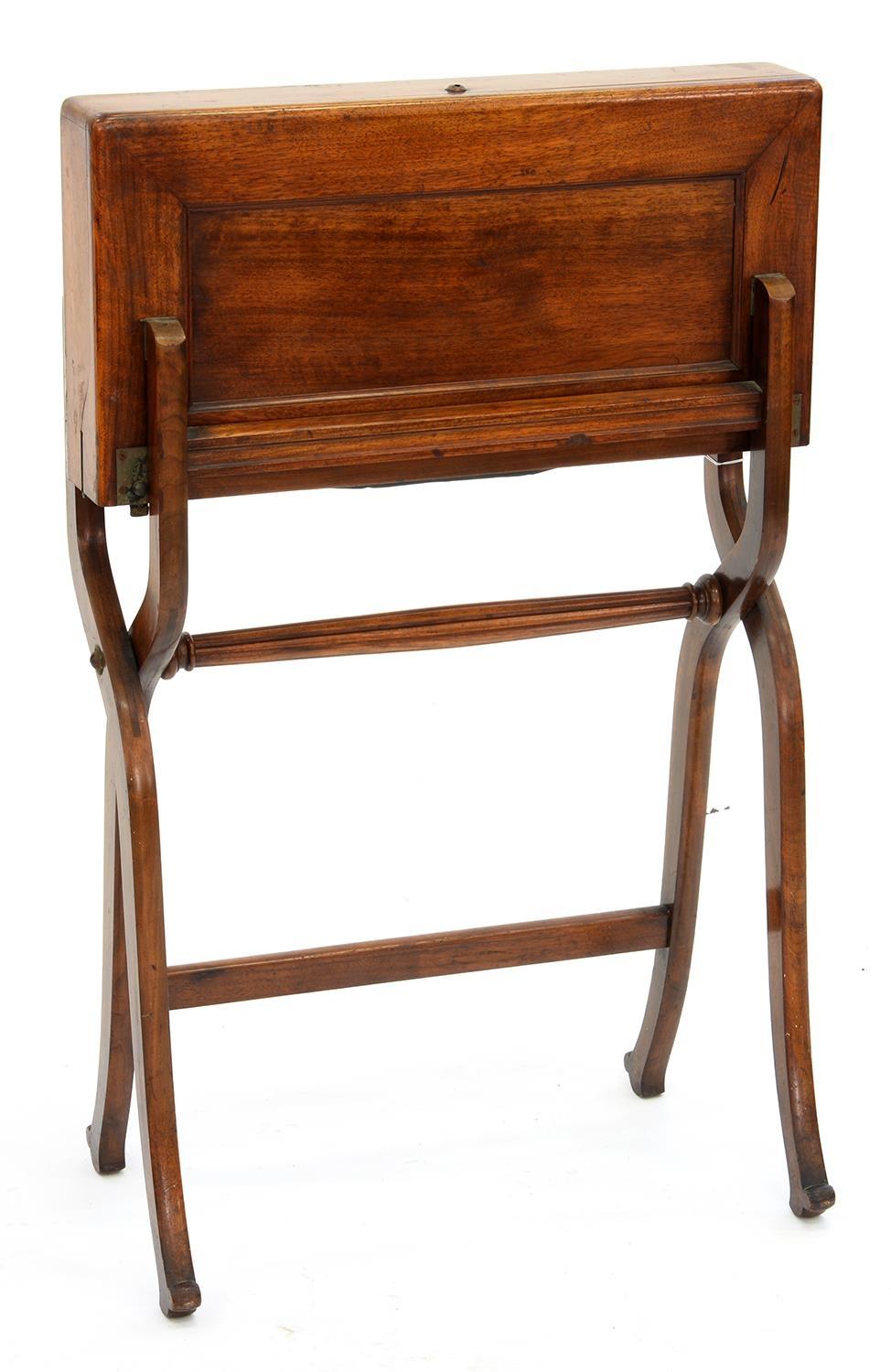 CAMPAIGN FURNITURE. AN EDWARDIAN MAHOGANY FOLDING WRITING TABLE WITH BLUE LEATHER FITTED INTERIOR,