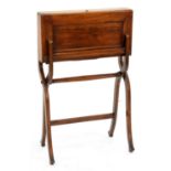 CAMPAIGN FURNITURE. AN EDWARDIAN MAHOGANY FOLDING WRITING TABLE WITH BLUE LEATHER FITTED INTERIOR,