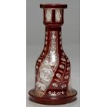 A RUBY FLASHED AND CUT GLASS BASE FOR A WATER PIPE (HUQQA), EARLY 20TH C, ENAMELLED IN WHITE WITH