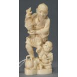 A JAPANESE IVORY OKIMONO OF A FISHERMAN AND BOY, MEIJI PERIOD, 12CM H, UNSIGNED Head broken off