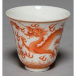 A CHINESE RED MONOCHROME  'MONTHS' WINE CUP, ENAMELLED WITH DRAGONS, GILT DETAIL, 5.5CM H,
