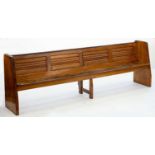 AN OAK PEW, EARLY 20TH C, 260CM W Numerous scuffs and scratches consistent with age and use. Back