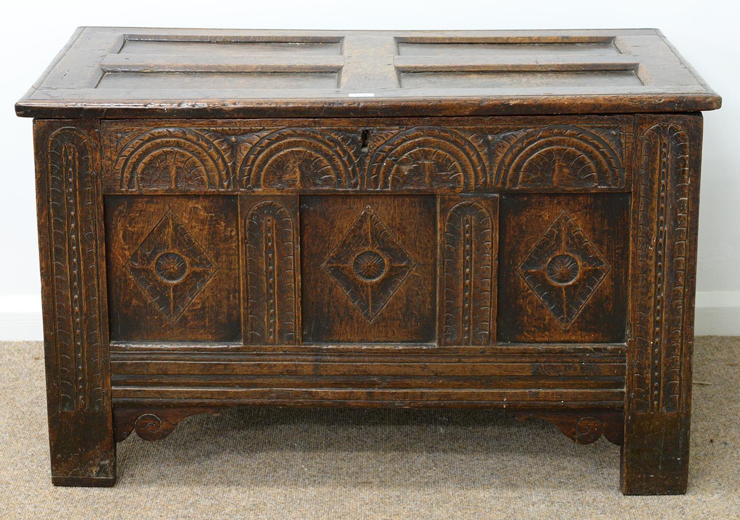 A CHARLES II JOINED OAK CHEST, LATE 17TH C, THE THREE PANEL FRONT CARVED AT LATER DATE WITH LUNETTES