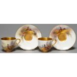 A PAIR OF ROYAL WORCESTER COFFEE CUPS AND SAUCERS, 1924 AND 1926, PAINTED BY JAS STINTON, EACH PIECE