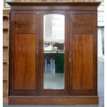 AN EDWARDIAN INLAID MAHOGANY WARDROBE, THE INTERIOR FITTED WITH DRAWERS AND TRAYS, MIRRORED DOOR