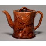 A ROCKINGHAM BROWN GLAZED BAMBOO FORM TEAPOT AND COVER, C1840, WITH RUSTIC HANDLE AND SPOUT AND