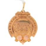 SHOWMENS' FELLOWSHIP. A 9CT GOLD GOLDEN JUBILEE CELEBRATIONS COMMEMORATIVE WATCH FOB SHIELD 1965,