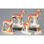 FIVE STAFFORDSHIRE EARTHENWARE MODELS OF GREYHOUNDS, MID 19TH C, THE FOUR LARGER WITH HARE, 19CM H