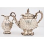 A VICTORIAN SILVER TEAPOT AND MILK JUG, GLOBULAR WITH RAISED OVAL PANELS ENGRAVED WITH FLOWERS