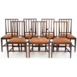 A SET OF SEVEN MAHOGANY DINING CHAIRS, INCLUDING ONE ELBOW CHAIR, ON SQUARE TAPERING LEGS, EARLY
